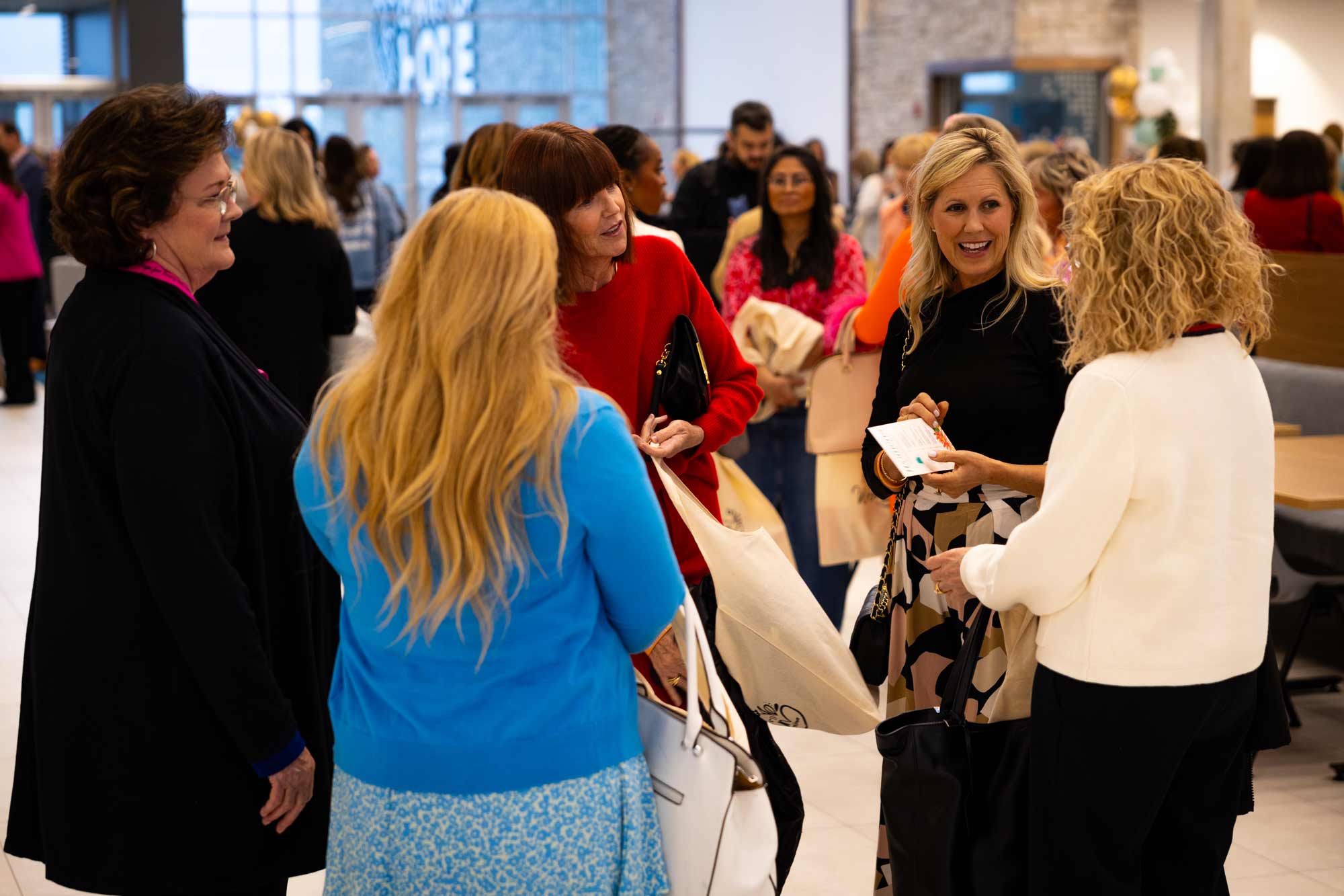 Guests talking together in the lobby before the event